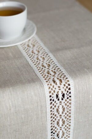beige linen table runner with off white linen lace in the center, the table see through.