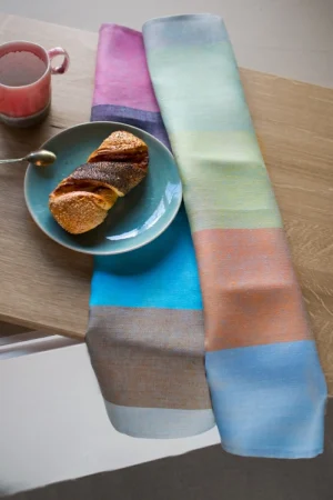 Set of Two towels with different stripes, one with more pastel colors and the other with bright hues.