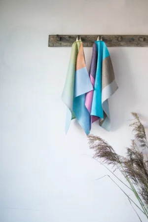 Set of 2 colorful striped linen towels. One with pastel colors wide stripes, the other with bright hues.