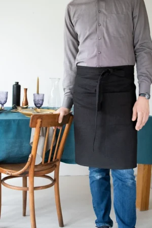 Black middle length linen unisex apron with one pocket and ling straps. Waist apron.