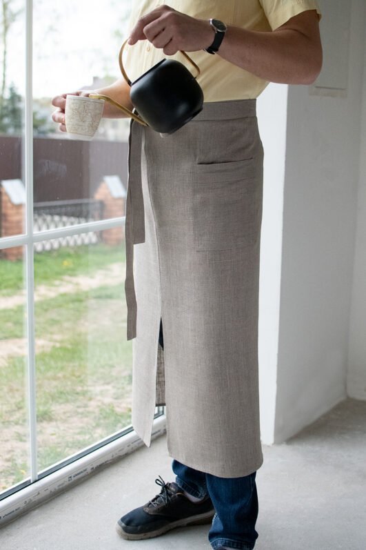 Natural linen long half apron is made with a slit on front and it helps to keep moving comfortable and the apron has the pockets on the sides. The belt is made long enough. Look great as cafe or restaurant apron. The apron can be used mostly in the kitchen, but can be great in the garden.