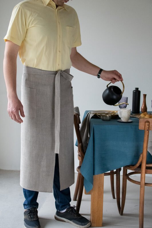 Natural linen long half apron is made with a slit on front and it helps to keep moving comfortable and the apron has the pockets on the sides. The belt is made long enough. Look great as cafe or restaurant apron. The apron can be used mostly in the kitchen, but can be great in the garden.