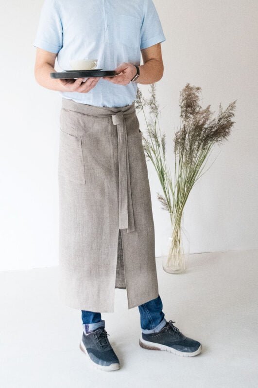 Natural linen long half apron is made with a slit on front and it helps to keep moving comfortable and the apron has the pockets on the sides. The belt is made long enough. Look great as cafe or restaurant apron. The apron can be used mostly in the kitchen, but can be great in the garden.