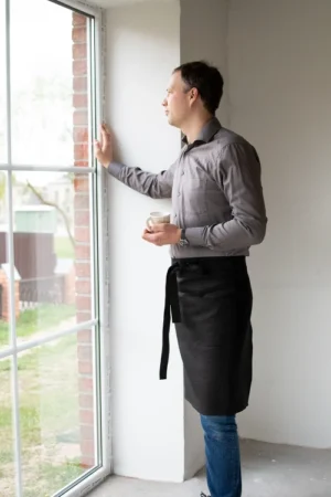 Black middle length linen unisex apron with one pocket and ling straps. Waist apron.