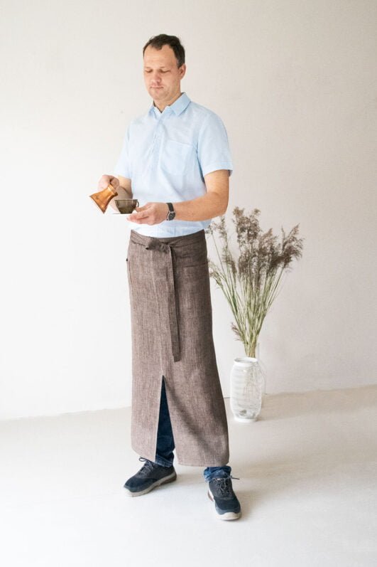 Brown linen long half apron is made with a slit on front and it helps to keep moving comfortable and the apron has the pockets on the sides. The belt is made long enough. Look great as cafe or restaurant apron.
