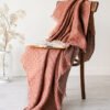 Rudy linen blanket with fringes and made from damask linen.
