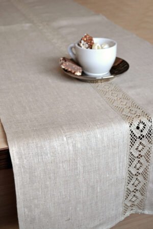 Light natural linen table runner with natural linen lace on the center of the table runner along the runner. Lace transparent and gauzy. Great decor for Your dinner table to special event.v
