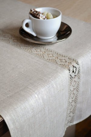 Light natural linen table runner with natural linen lace on the center of the table runner along the runner. Lace transparent and gauzy. Great decor for Your dinner table to special event.