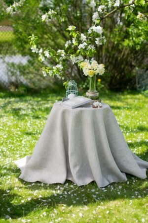 Light natural round linen tablecloth on small table goes to the ground in so wonderful deep folds. This circle linen tablecloth layers on the ground looks so luxury. It is so elegant for Your party with family and friends.