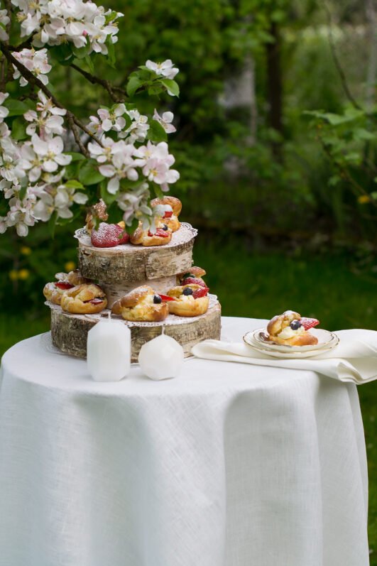 Off white round linen tablecloth on small table goes to the ground in so wonderful deep folds. This linen tablecloth layers on the ground looks so luxury. It is so elegant for Your party in the garden or at home.