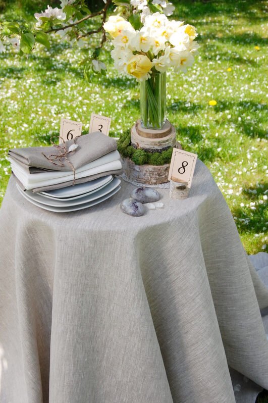 Light natural round linen tablecloth on small table goes to the ground in so wonderful deep folds. This circle linen tablecloth layers on the ground looks so luxury. It is so elegant for Your party with family and friends.
