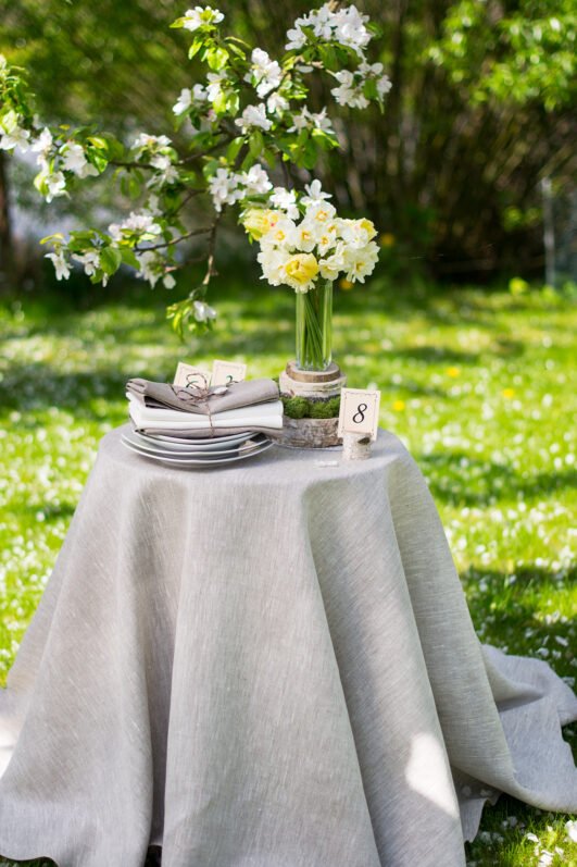 Light natural round linen tablecloth on small table goes to the ground in so wonderful deep folds. This circle linen tablecloth layers on the ground looks so luxury. It is so elegant for Your party with family and friends.