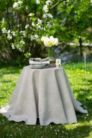 Light natural round linen tablecloth on small table goes to the ground in so wonderful deep folds. This circle linen tablecloth layers on the ground looks so luxury. It is so elegant for Your party with family and friends.