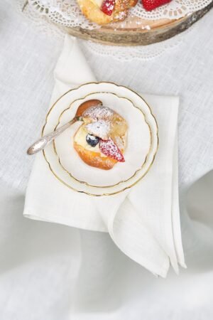 Off white round linen tablecloth on small table goes to the ground in so wonderful deep folds. This linen tablecloth layers on the ground looks so luxury. It is so elegant for Your party in the garden or at home.