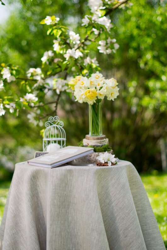 Light natural round linen tablecloth on small table goes to the ground in so wonderful deep folds. This circle linen tablecloth layers on the ground looks so luxury. It is so elegant for Your party with family and friends.