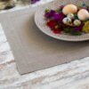 Elegant linen placemats in neutral tones (natural, light natural, off-white) with wide mitered corners. Perfect for casual or formal dining. Shop now for simple, natural table decor.