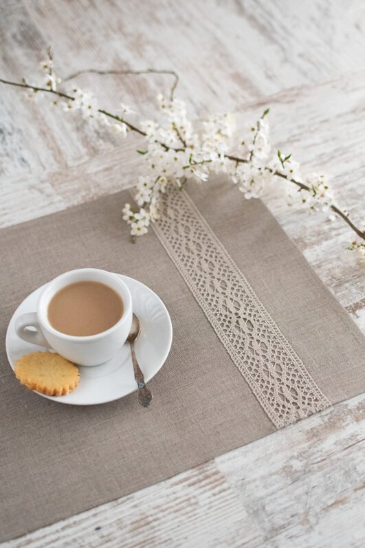 Natural linen placemats with natural lace on one side, rustic farmhouse style for breakfast or brunch with friends.