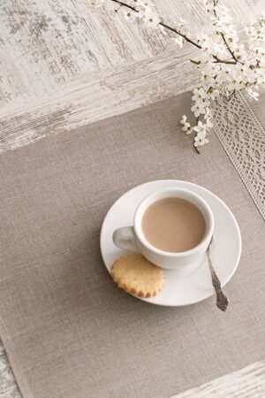 Natural linen placemats with natural lace on one side, rustic farmhouse style for breakfast or brunch with friends.
