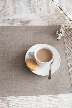 Natural linen placemats with natural lace on one side, rustic farmhouse style for breakfast or brunch with friends.