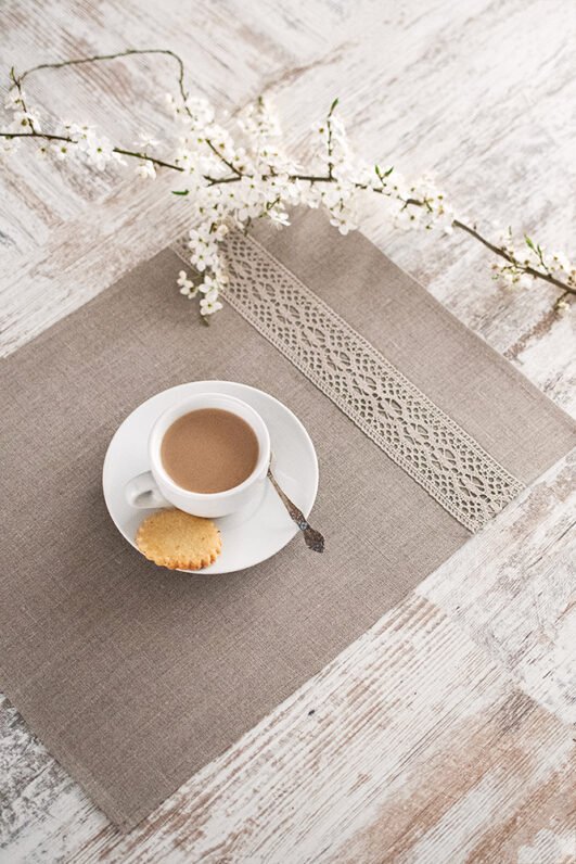 Natural linen placemats with natural lace on one side, rustic farmhouse style for breakfast or brunch with friends.