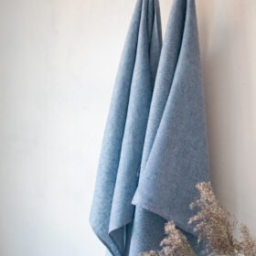 Blue linen herringbone bath towel, with a hanging loops. Blue color is lighter blue.