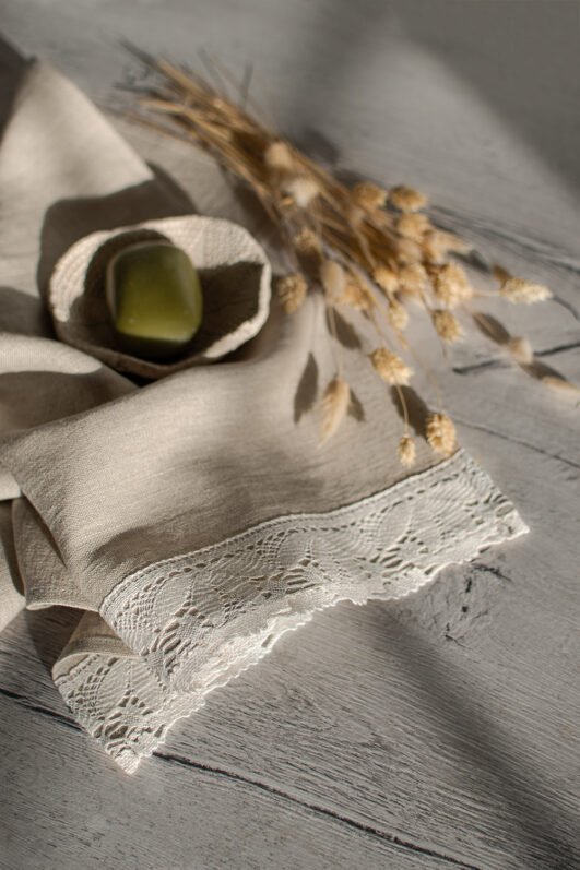 Shabby chic natural linen towels decorated with white luxury wide linen lace with lotus flowers. So great to decor bathroom.