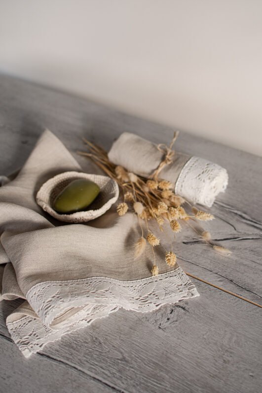 Shabby chic natural linen towels decorated with white luxury wide linen lace with lotus flowers. So great to decor bathroom.