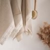 Shabby chic natural linen towels decorated with white luxury wide linen lace with lotus flowers.