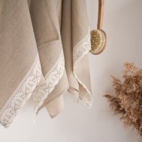 Shabby chic natural linen towels decorated with white luxury wide linen lace with lotus flowers.