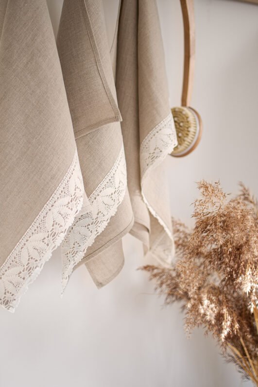 Shabby chic natural linen towels decorated with white luxury wide linen lace with lotus flowers. So great to decor bathroom.