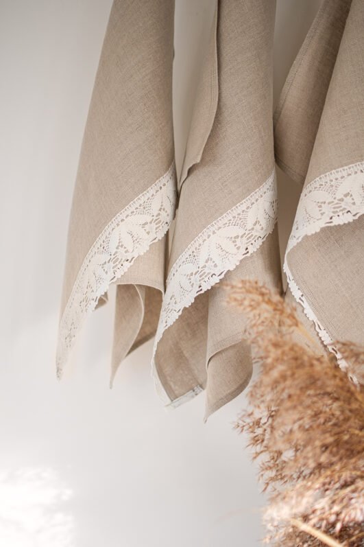 Shabby chic natural linen towels decorated with white luxury wide linen lace with lotus flowers. So great to decor bathroom.