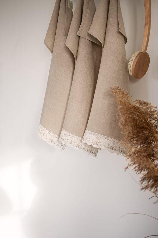 Shabby chic natural linen towels decorated with white luxury wide linen lace with lotus flowers. So great to decor bathroom.