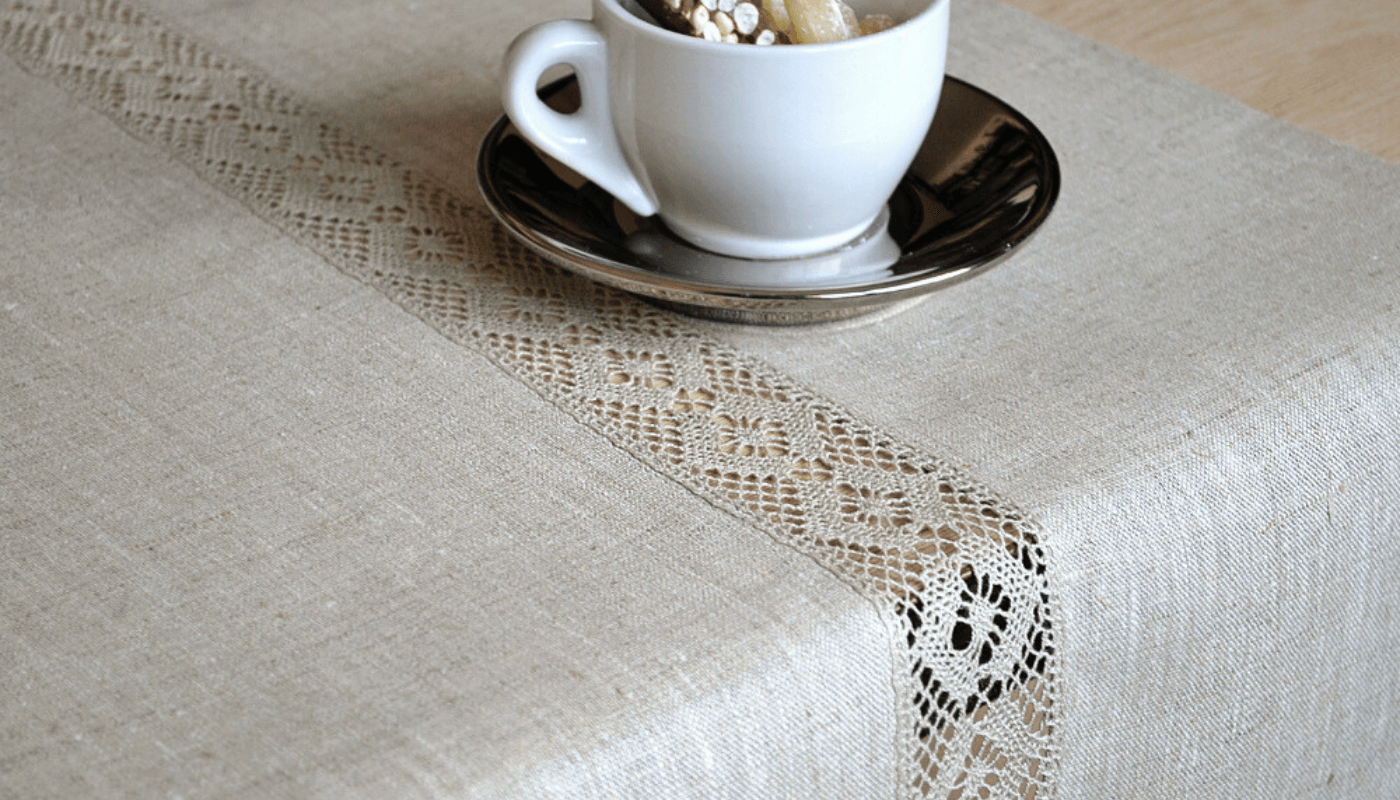 Neutral linen table runner with linen lace on the center.