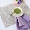 Damask linen placemats with mitered corners. Damak's pattern is woven from linen and cotton in natural shades. And easaly can be combined with our lavender napkins.