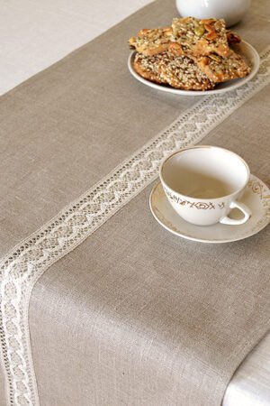 Natural linen table runner with the narrow white with natural linen lace on the center.