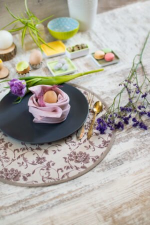 Reversible round linen cotton placemat showing both the Marsala floral side and the natural linen side with finished binding.