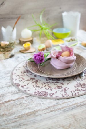 Reversible round linen cotton placemat showing both the Marsala floral side and the natural linen side with finished binding.