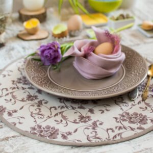 Reversible round linen cotton placemat showing both the Marsala floral side and the natural linen side with finished binding.