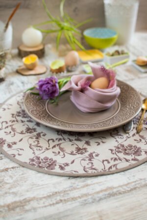 Reversible round linen cotton placemat showing both the Marsala floral side and the natural linen side with finished binding.