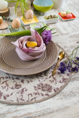 Reversible round linen cotton placemat showing both the Marsala floral side and the natural linen side with finished binding.