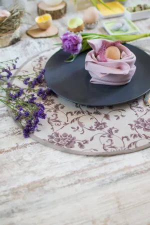 Reversible round linen cotton placemat showing both the Marsala floral side and the natural linen side with finished binding.