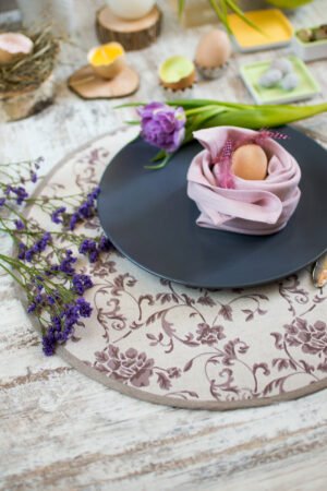Reversible round linen cotton placemat showing both the Marsala floral side and the natural linen side with finished binding.